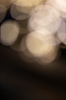 Warm-toned abstract bokeh circles create a dreamy, blurred visual effect.