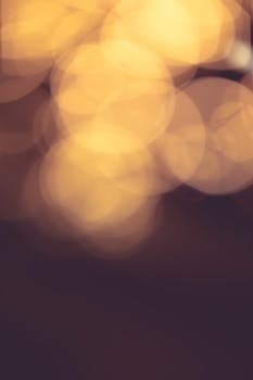 Soft, blurred warm bokeh lights creating a calming, abstract background ideal for design use.