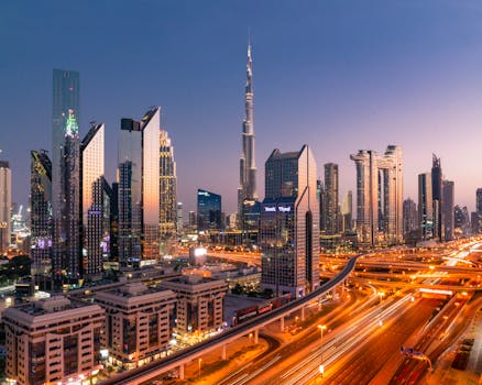 Stunning cityscape of Dubai with the Burj Khalifa and city lights illuminating the skyline at twilight.