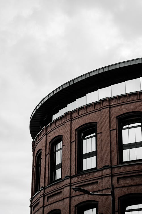 Photo of Brick Building Under Cloudy Sky