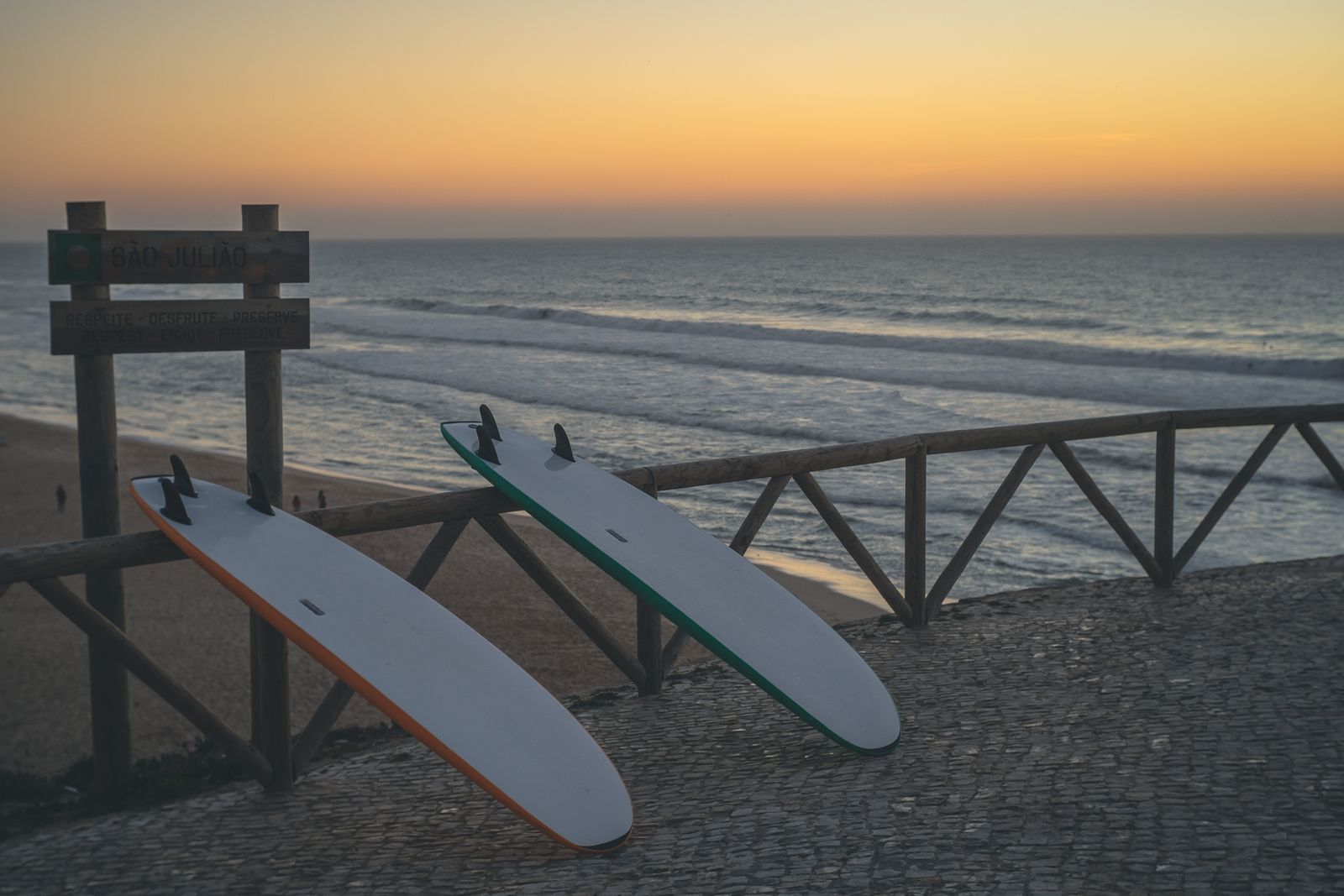 Surfboards above the ocean at sunset in Ericeira.