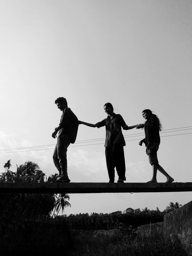 Monochrome Photo Of People Crossing A Bridge