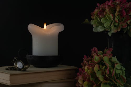 Photo of Candle and Pocketwatch on top of Book