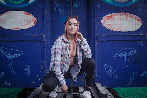 A Woman in Plaid Shirt Crouching