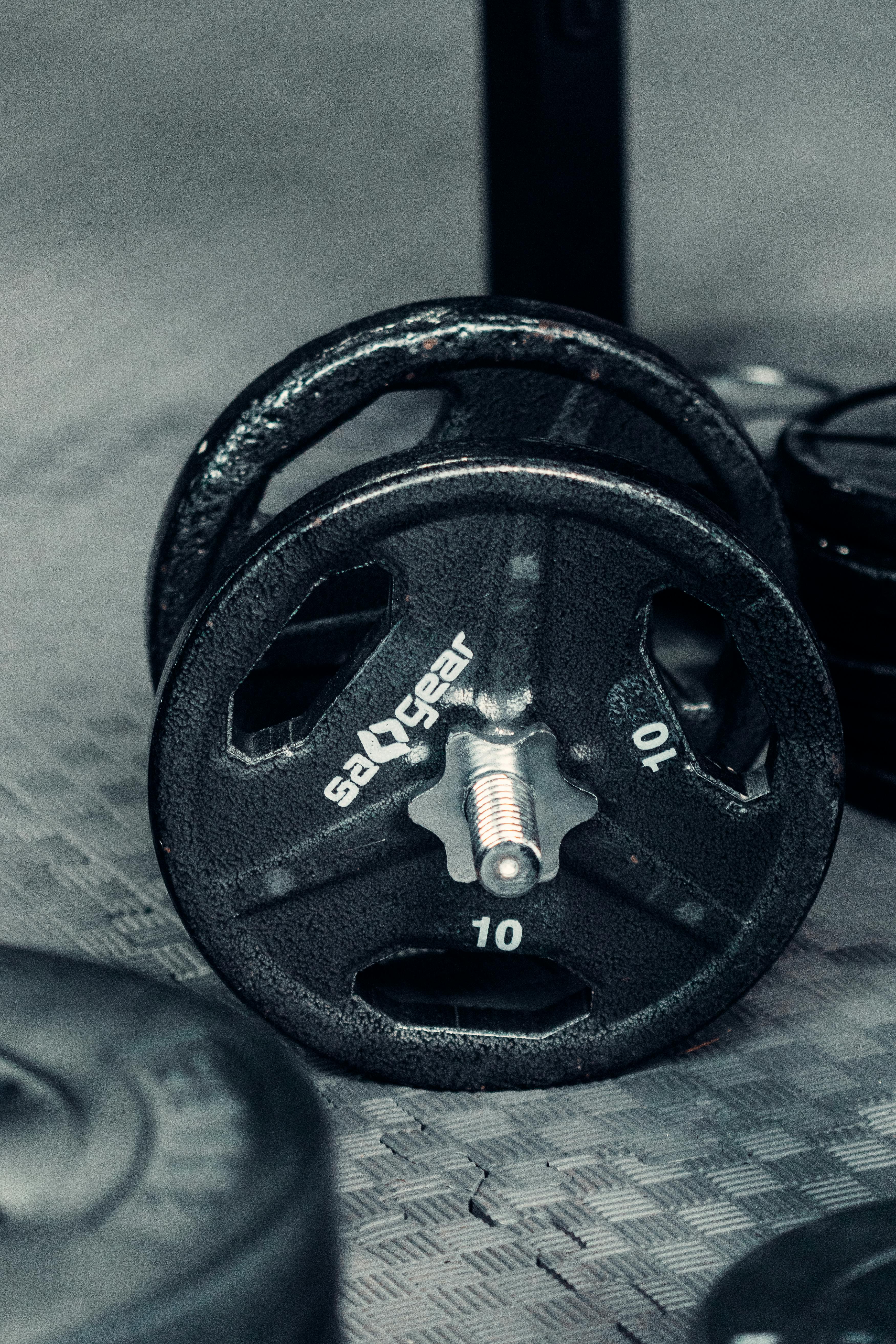 heavy iron dumbbell on rubber gym floor