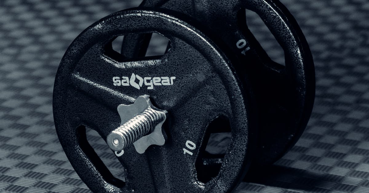 Dumbbell on rubber mat in sports hall