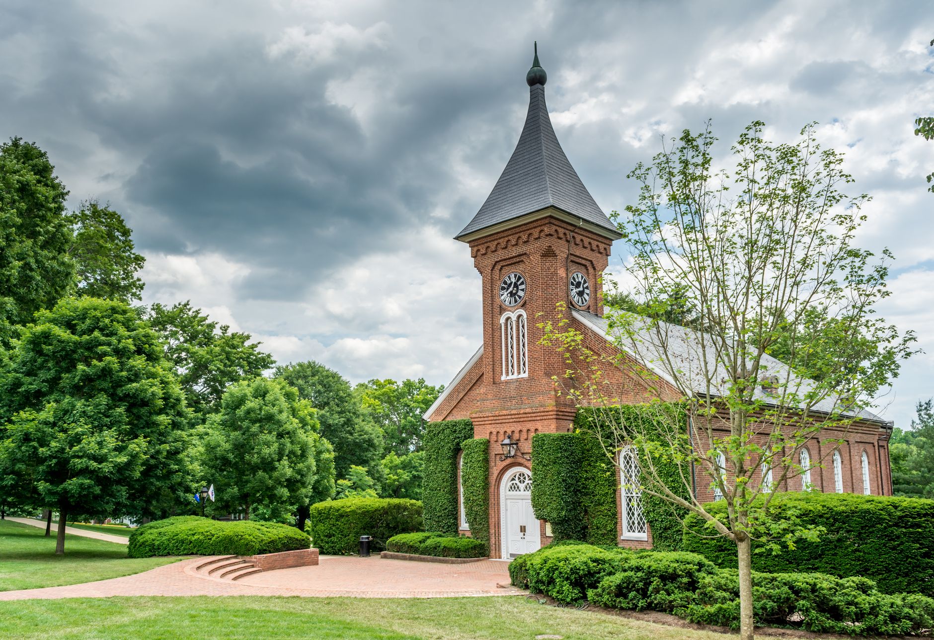 A historic brick chapel with a clock tower surrounded by greenery in Lexington, VA.