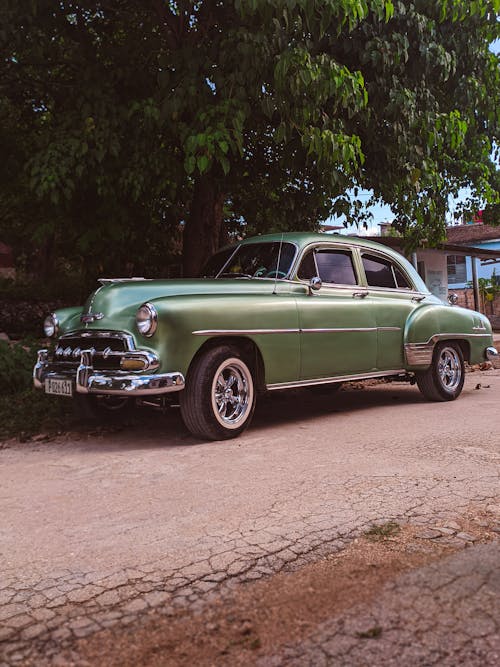 Green Vintage Car parked on Road