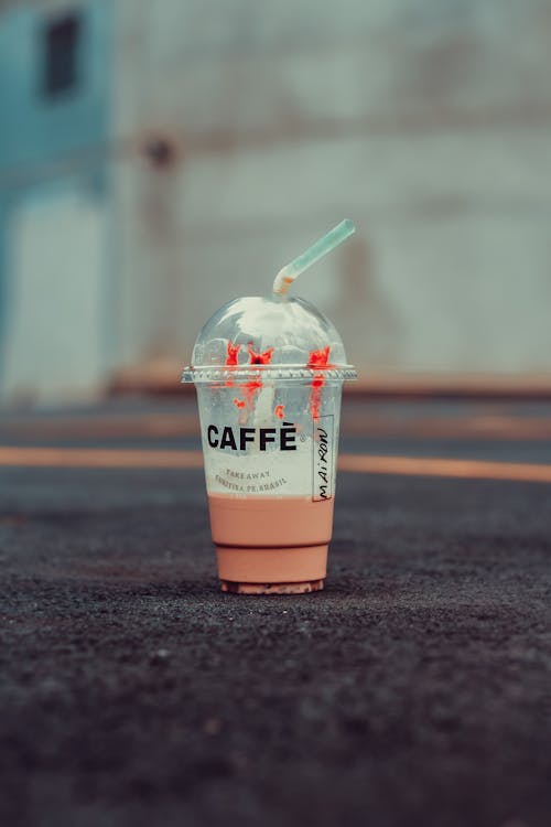 Tilt-shift Photography of Plastic Cup on Ground
