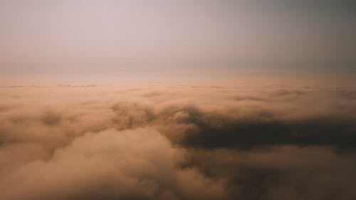 Spectacular view of atmosphere with clouds under gray sky with horizon at sunset