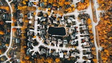 Housing complex near roads and colorful trees in fall