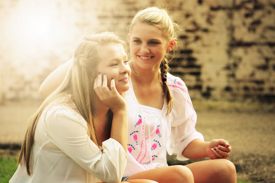 Two Women Sitting Down Smiling