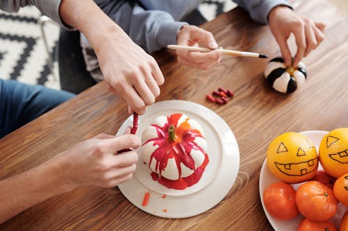 People Painting Pumpkins