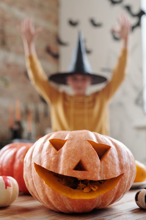 Child celebrating after carving a pumpkin