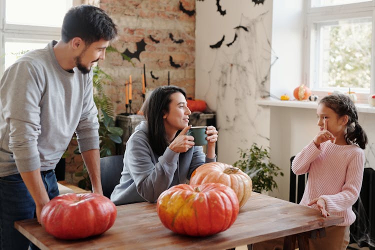 A Happy Family Spending Leisure Time Before Carving Pumpkins