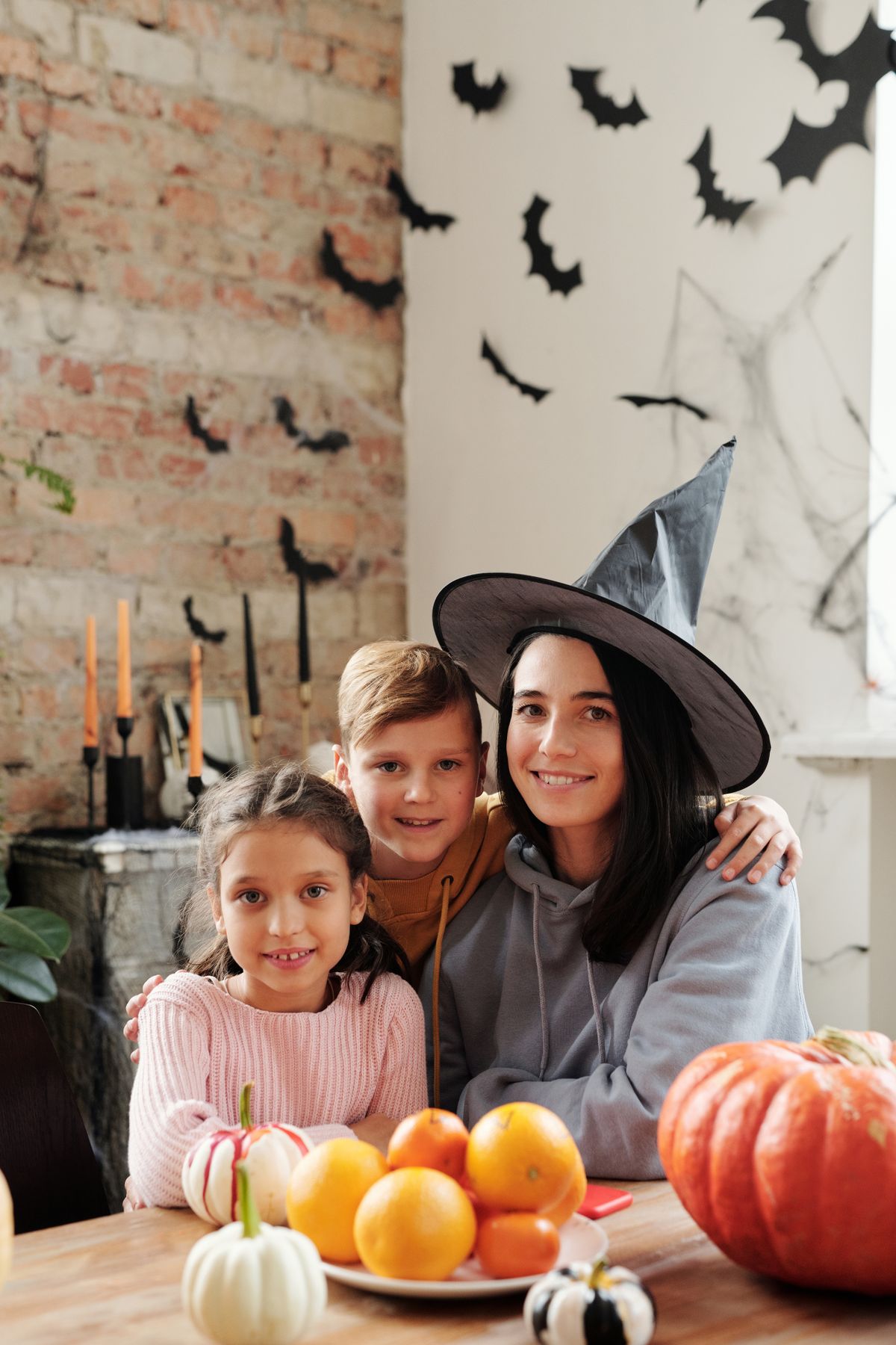 A family celebrating Halloween together with pumpkins and decorations.