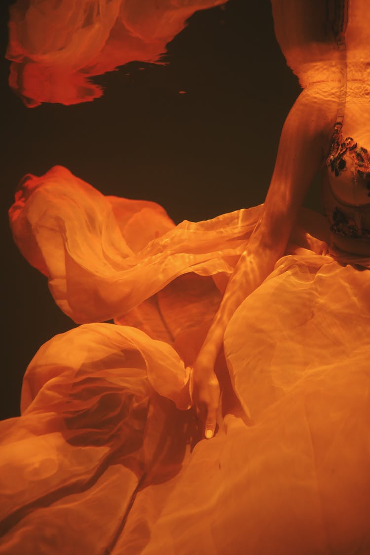 Woman Wearing Sheer Dress Submerged Underwater 