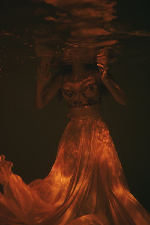 Woman wearing Sheer Dress submerged underwater 