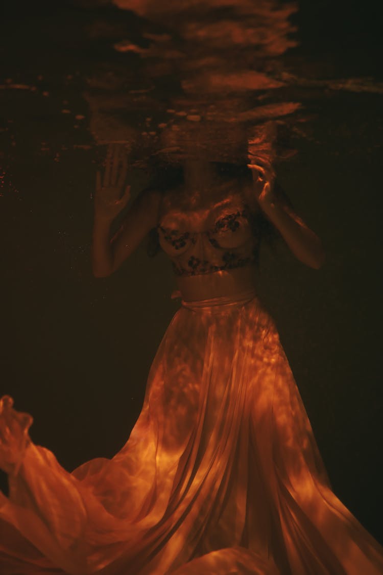 Woman Wearing Sheer Dress Submerged Underwater 