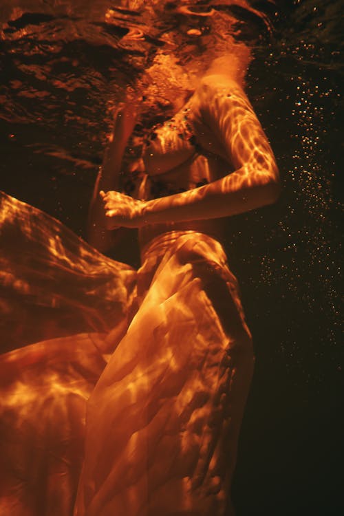 Woman wearing Sheer Dress submerged underwater 
