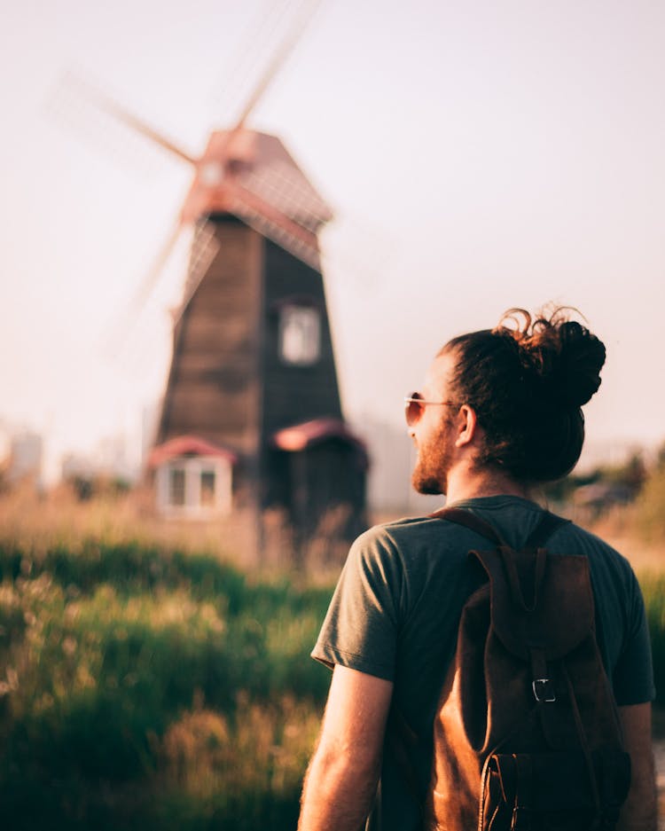 Backview Of Man Wearing Brown Backpack 