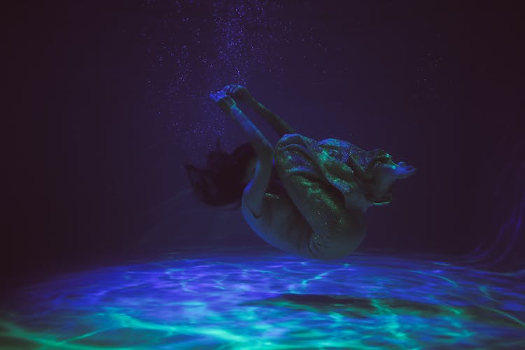 Woman Curled Up Underwater 