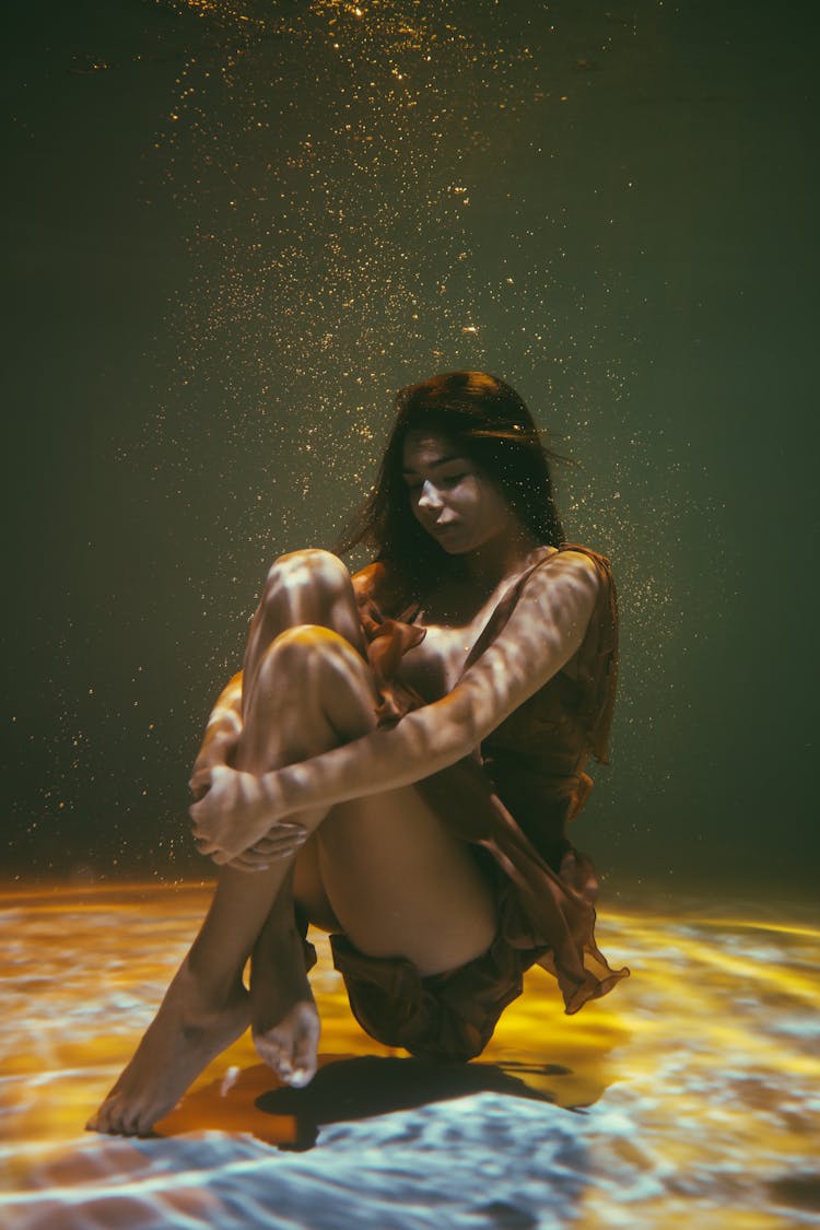 Graceful Woman Sitting Underwater 