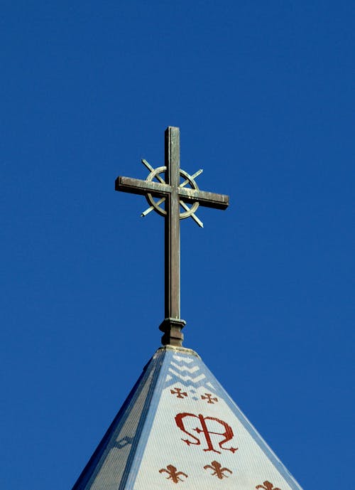 Close-up Photo of Cross Under Blue Sky