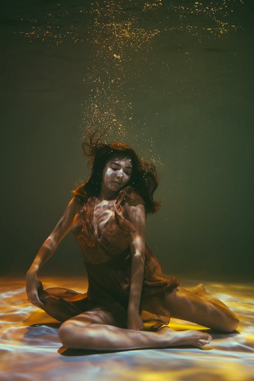 A Woman in a Dress Underwater
