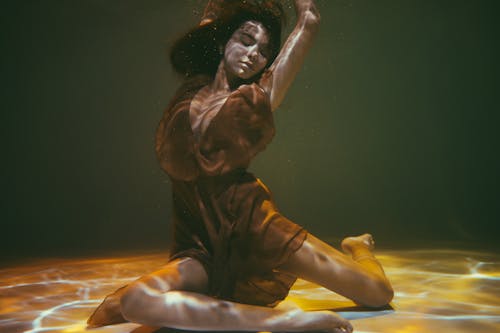 A Woman in a Dress Posing Underwater