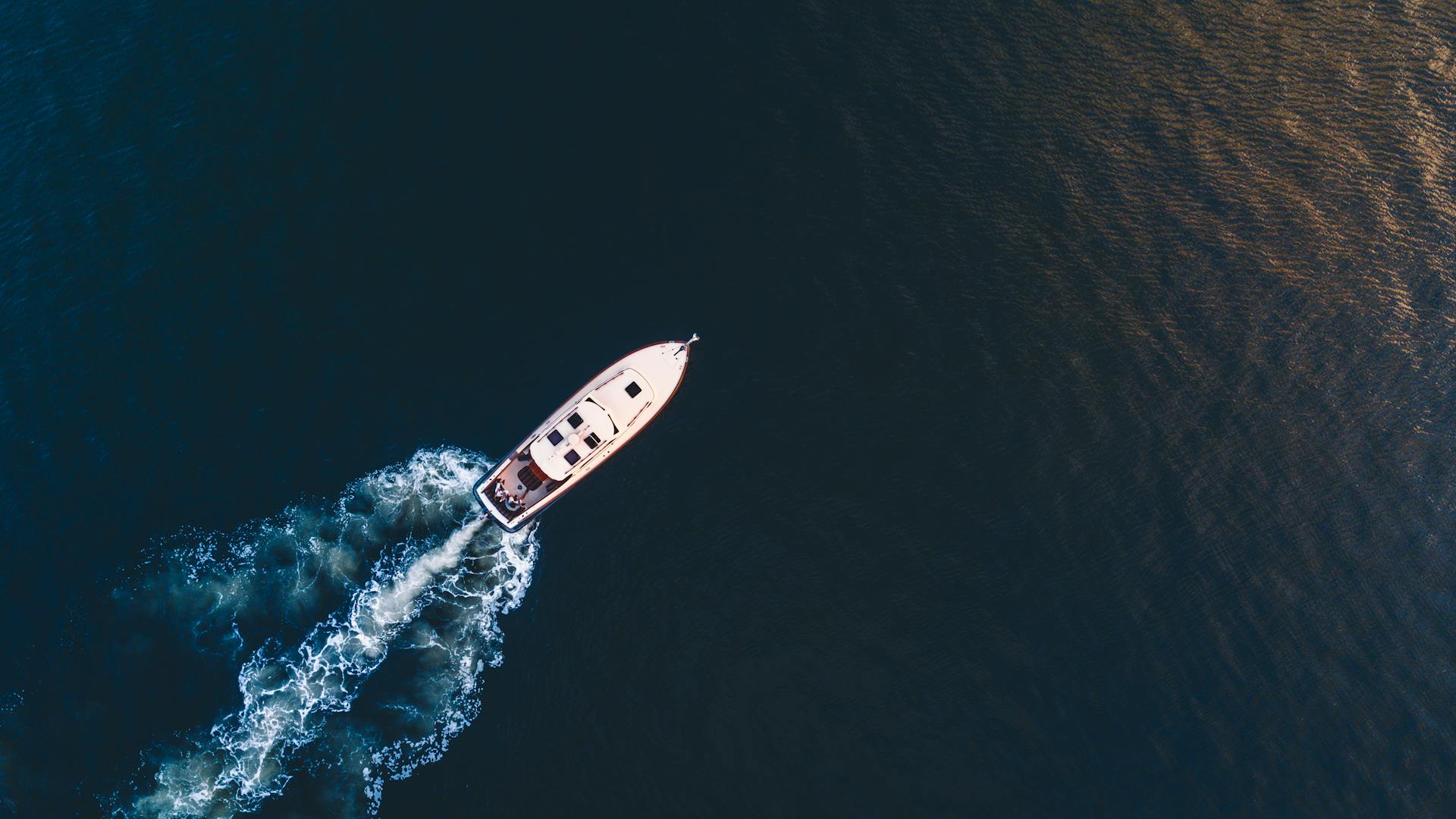 An Aerial Shot of a Boat Sailing on the Sea