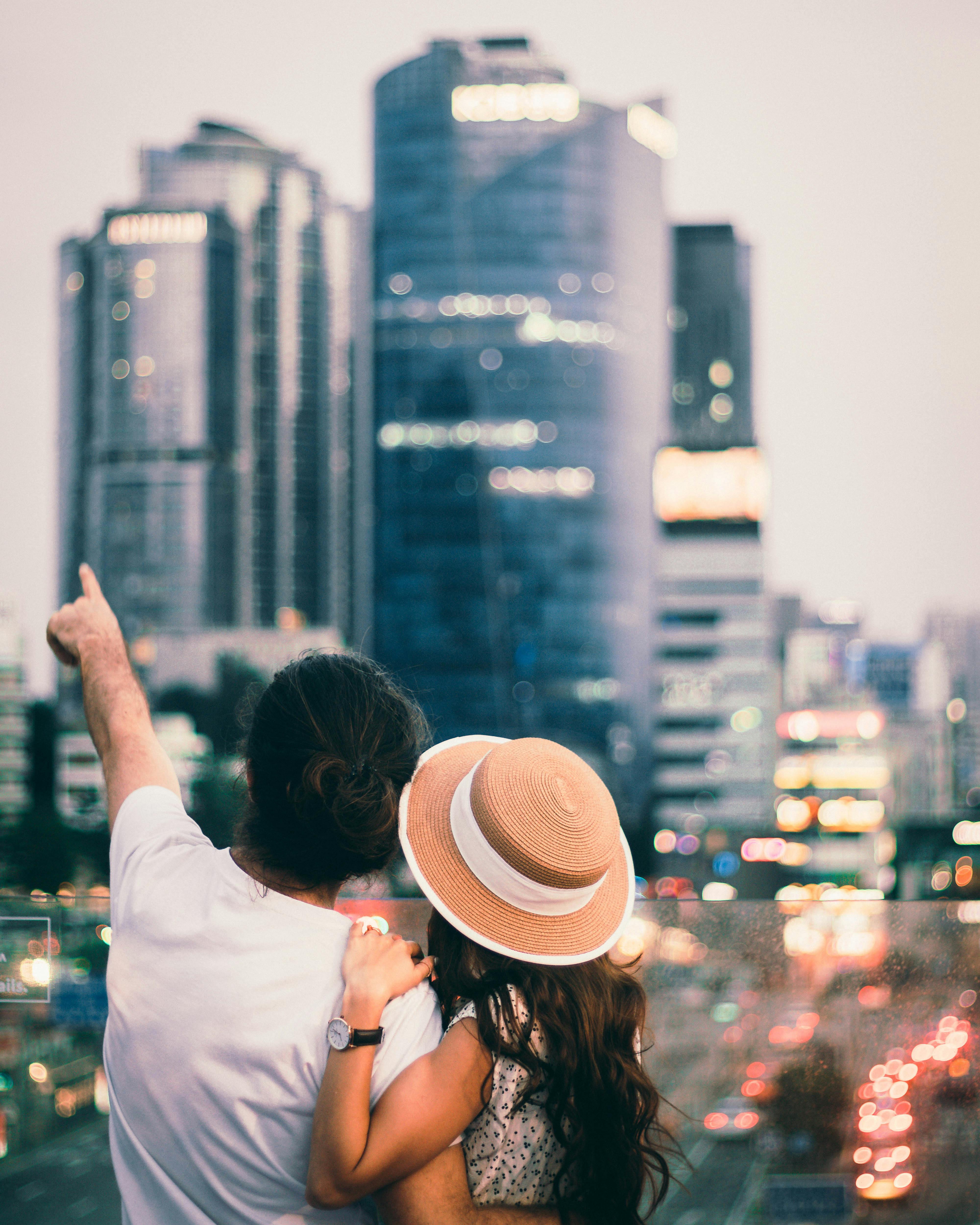 a couple looking at city buildings