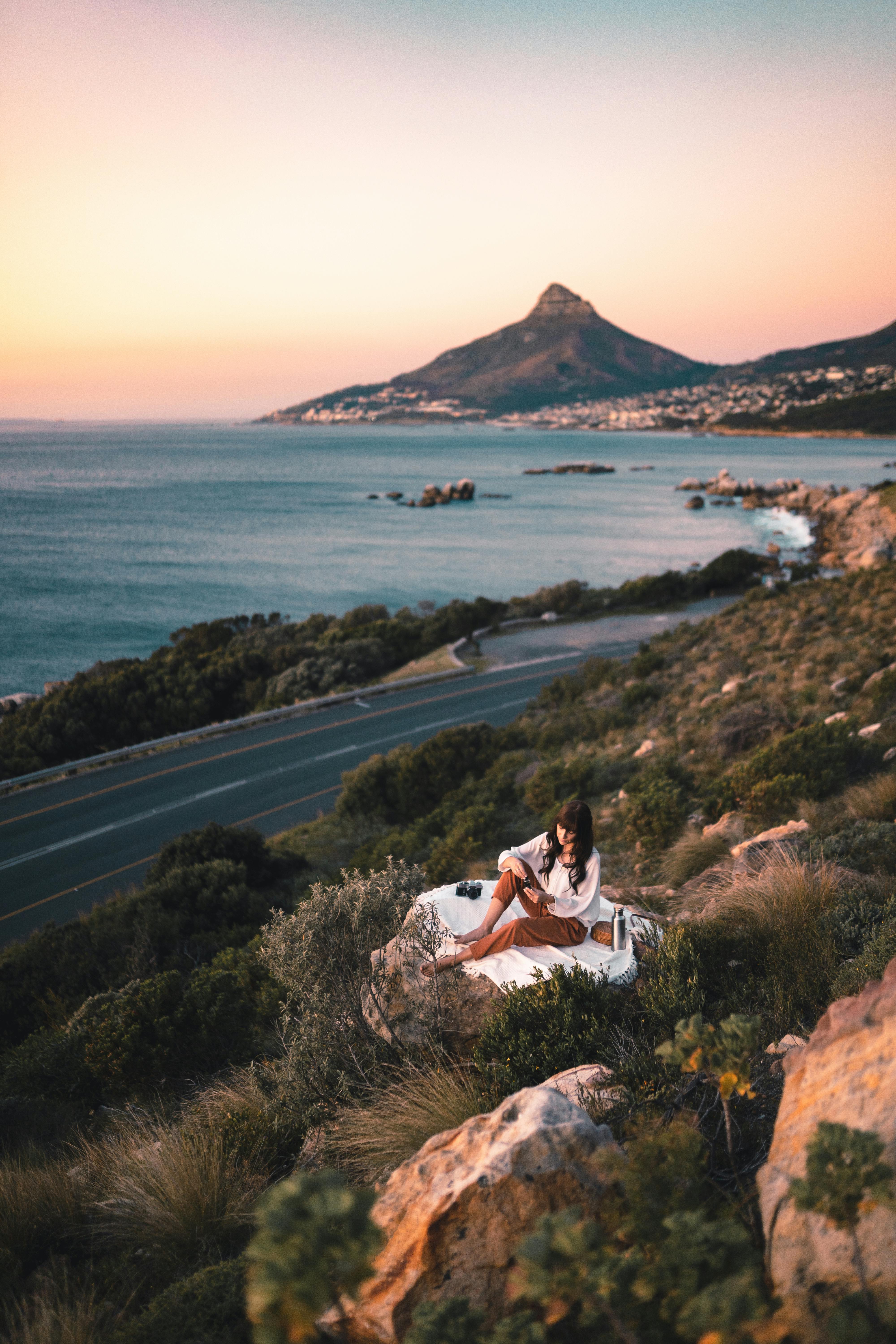 a woman resting on a rock