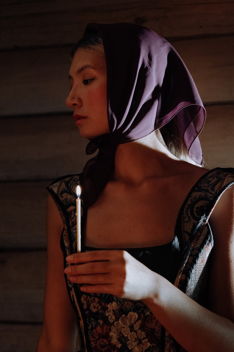 Woman Wearing Headdress Holding Lighted Candle