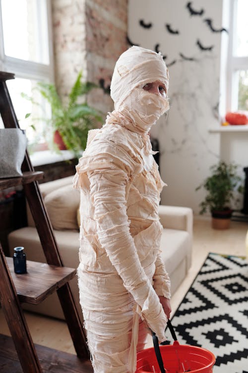Kid Wearing A Mummy Costume With A Bucket · Free Stock Photo