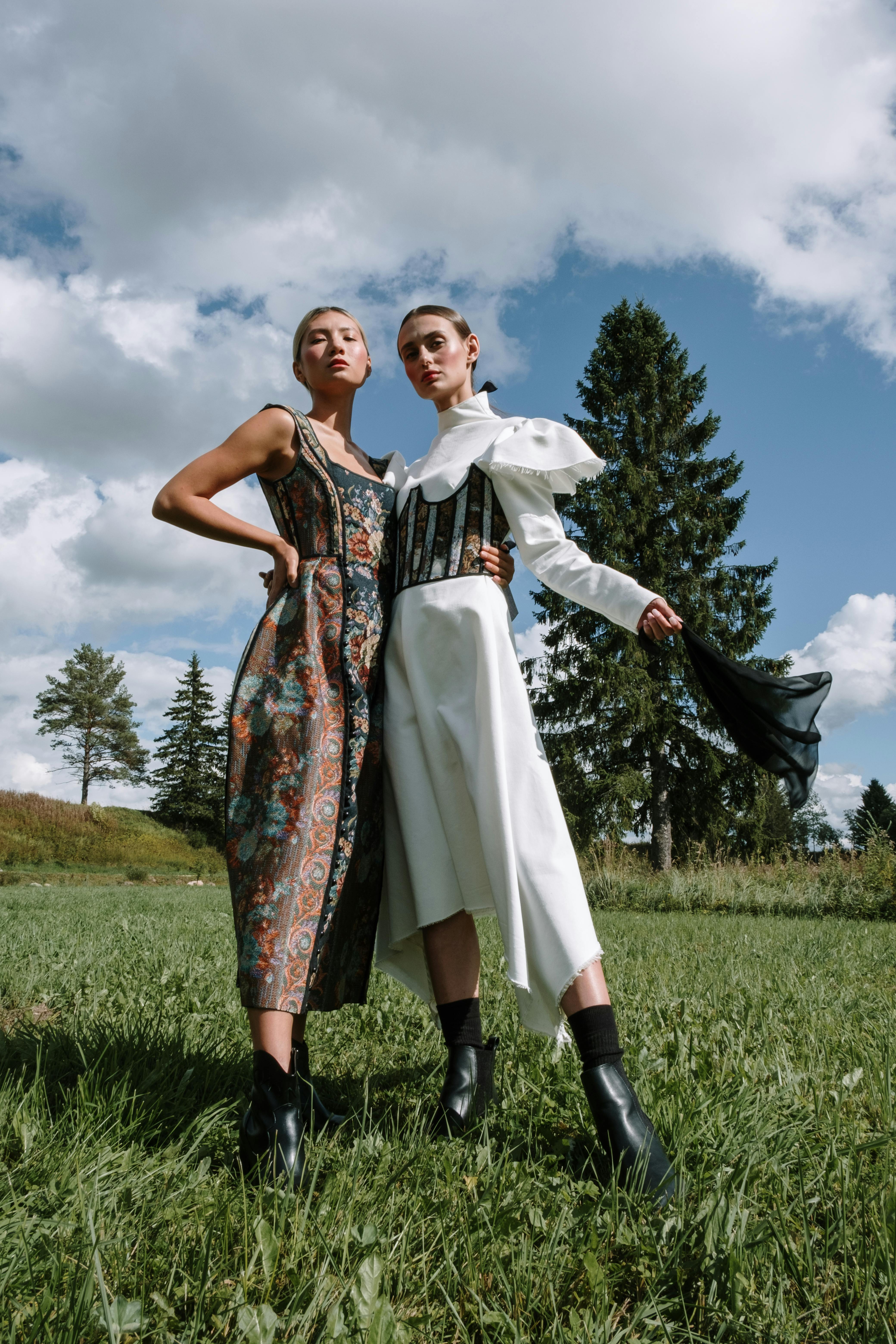 elegant women standing beside each other