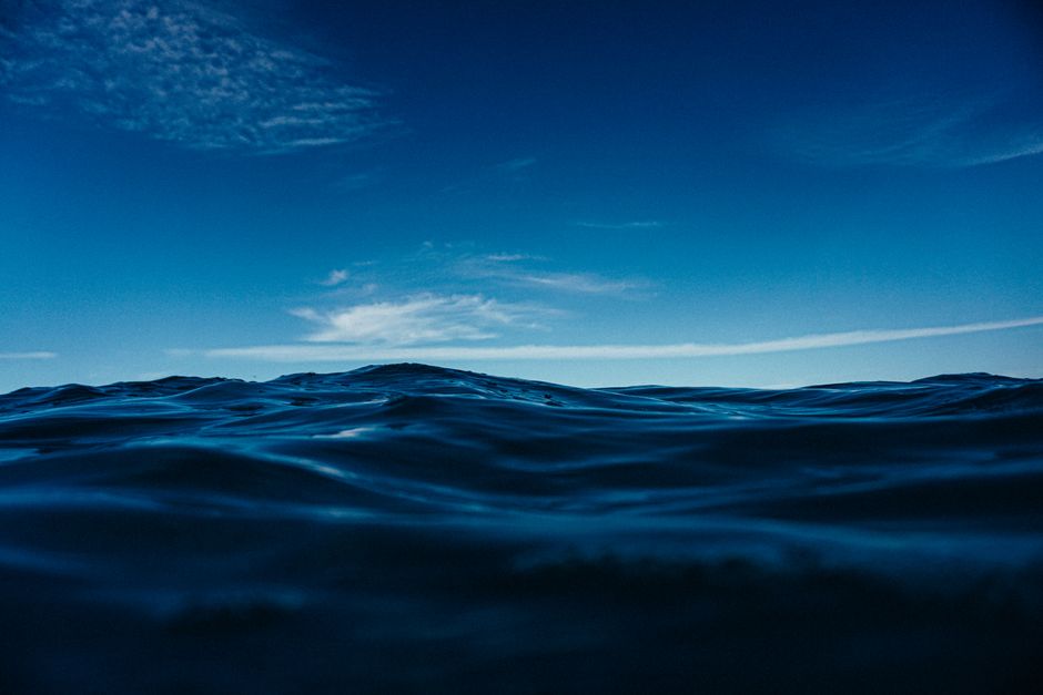 Seascape of bright blue waves of sea water flowing under blue sky at daylight