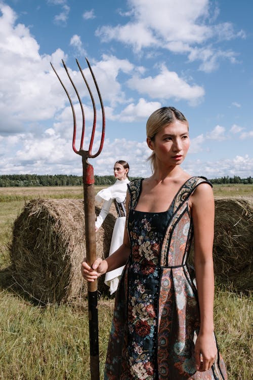 Two Women in Stylish Outfits Standing on a Farm