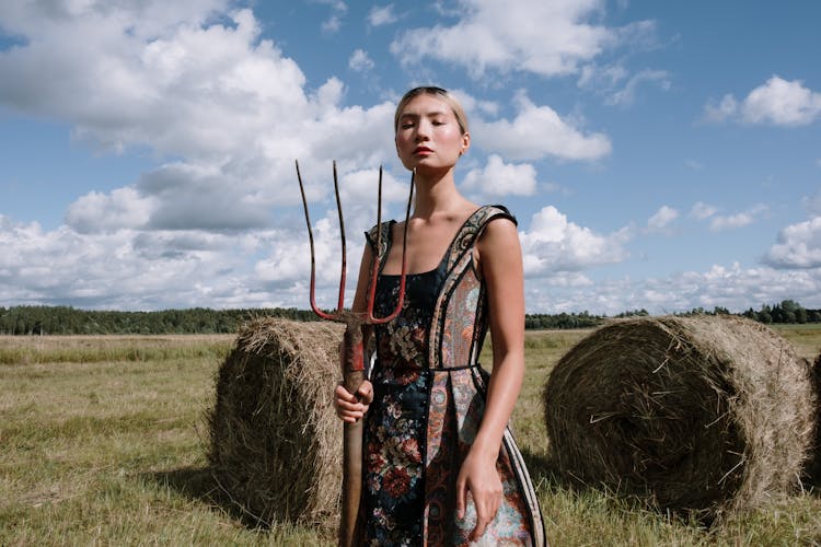 Elegant Woman Holding Pitchfork 