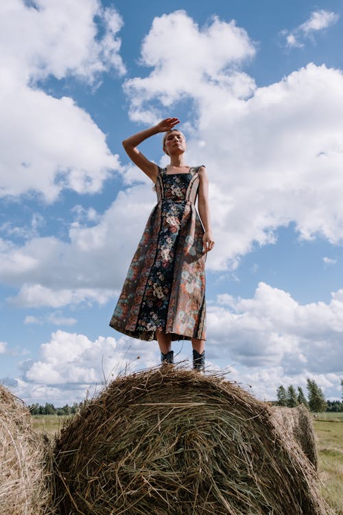 A Woman Standing on Top of a Hay