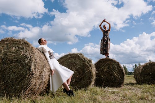 Stylish Dresses worn by Models standing on Straw and Hays