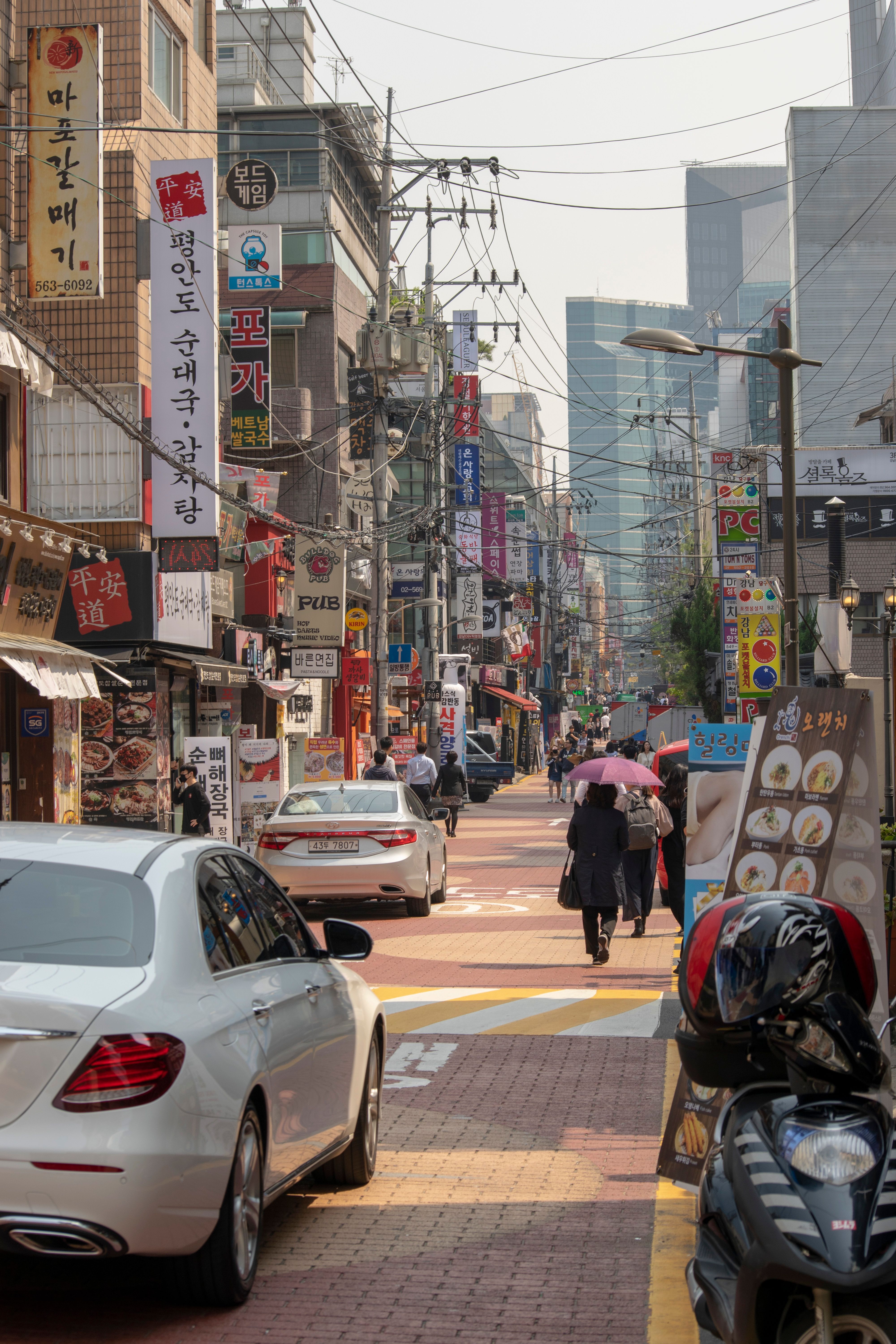 Vibrant street view with shops and pedestrians in Hongcheon, South Korea.