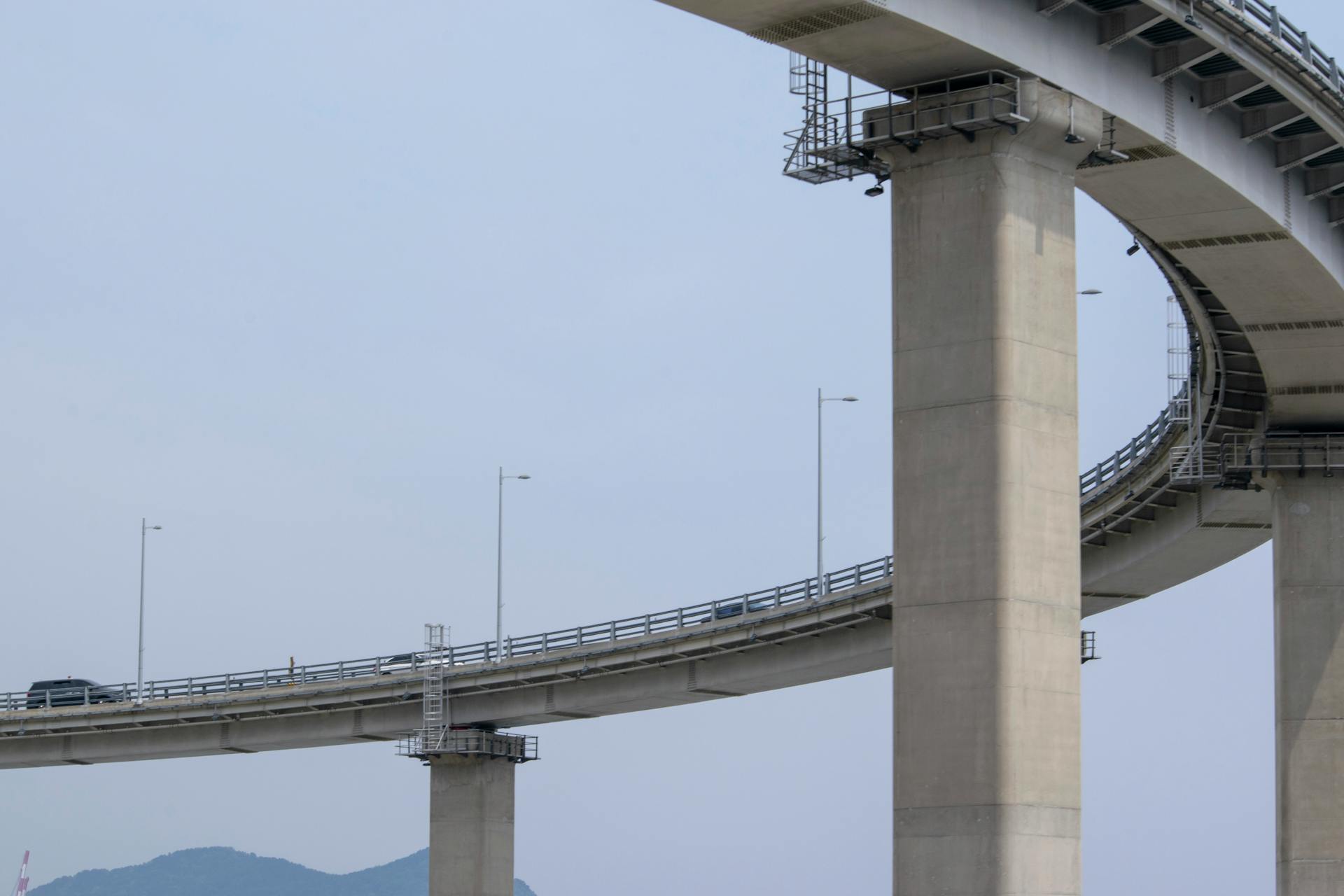 Elegant structure of an elevated concrete highway bridge with a loop design, showcasing modern infrastructure.