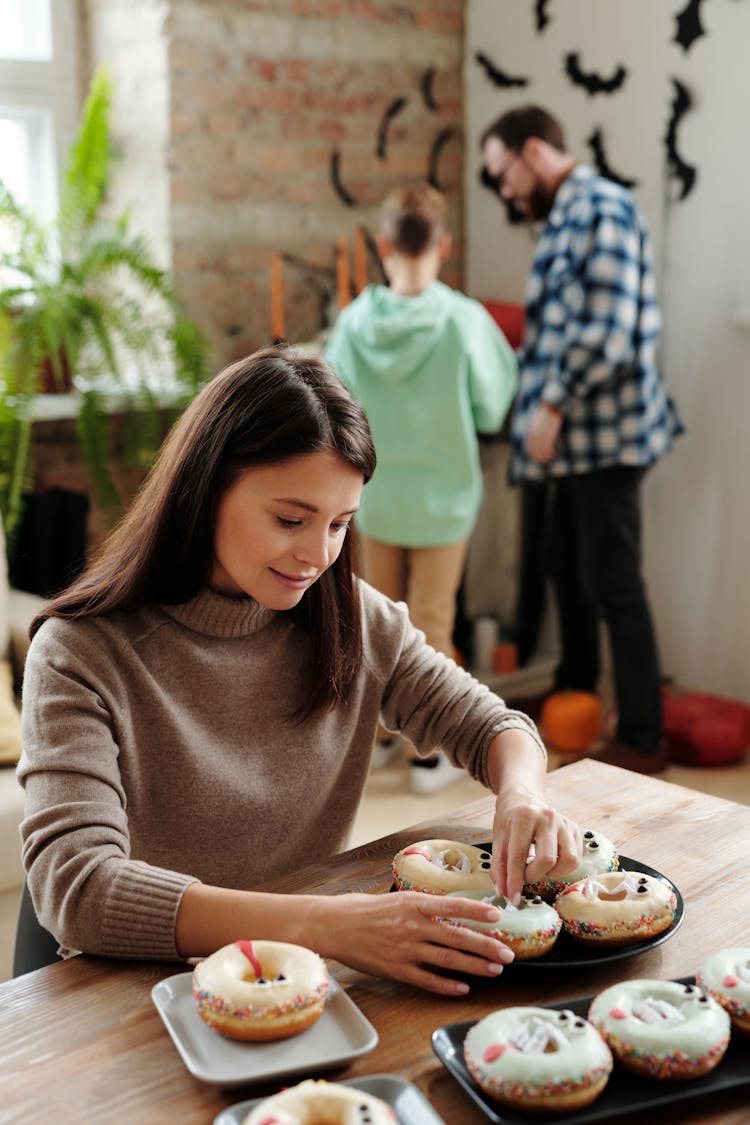 Woman Decorating A Halloween Donut