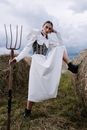 Woman Holding a Fitchfork