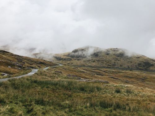 Free A misty view of the rugged mountains and lush greenery in Snowdonia, Wales. Stock Photo