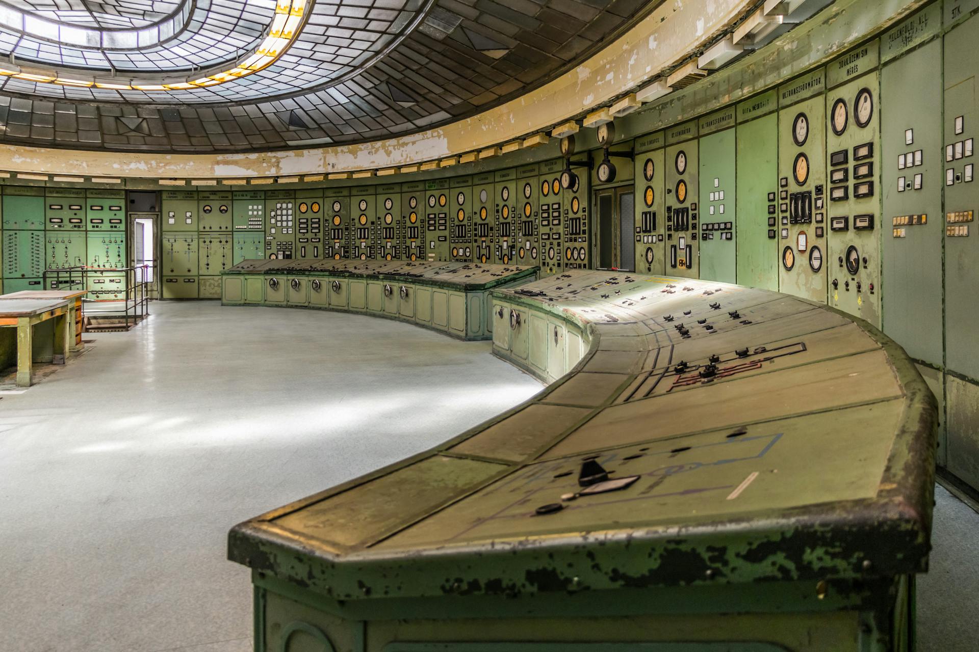 Retro industrial control room with vintage panels and dials in an old power plant.