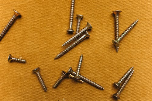 Screws on Yellow Surface 
