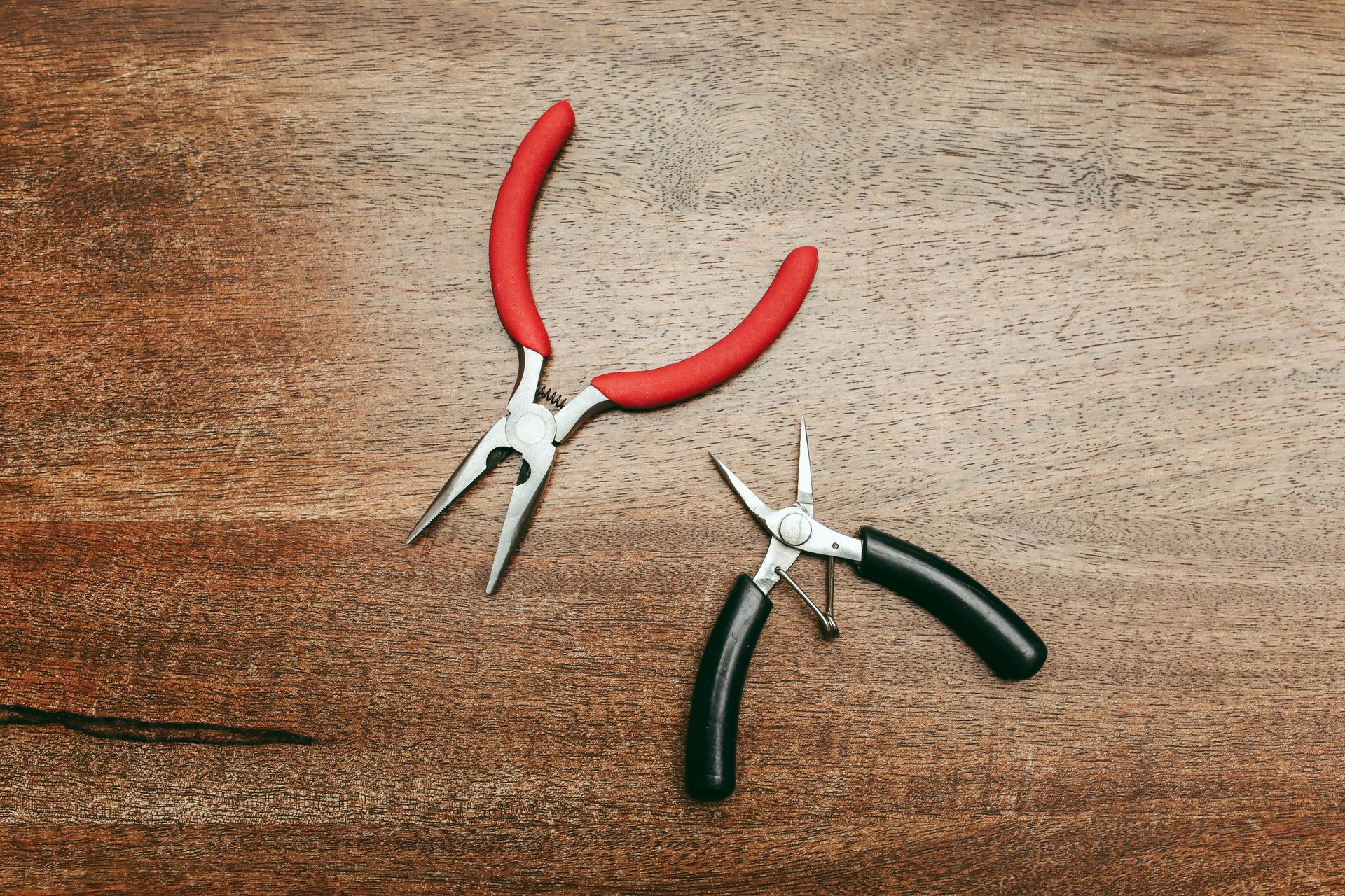 Close-Up Shot of Pliers on a Wooden Surface