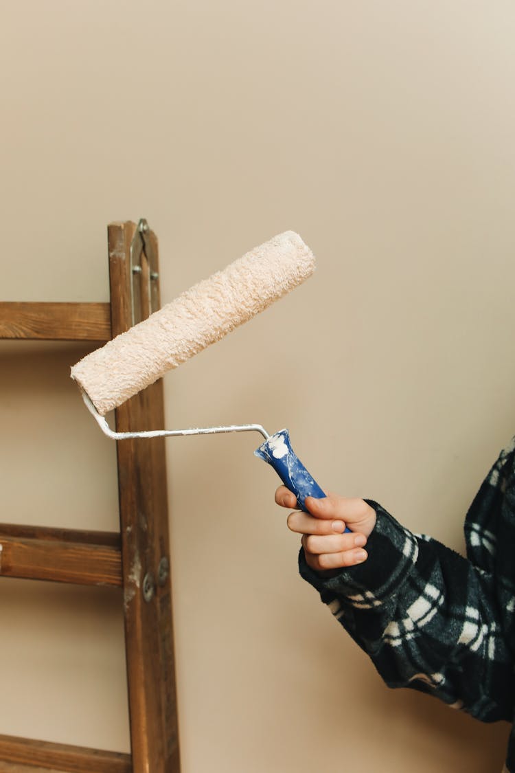 Hand Holding Paint Roller